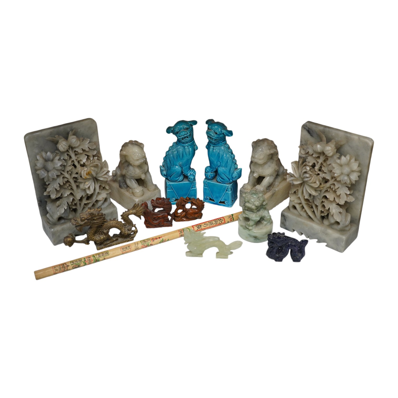 A group of Chinese items; a pair of turquoise glazed ceramic lion dogs, two pairs of soapstone carvings, various ‘dragon’ carvings etc. Condition - fair to good